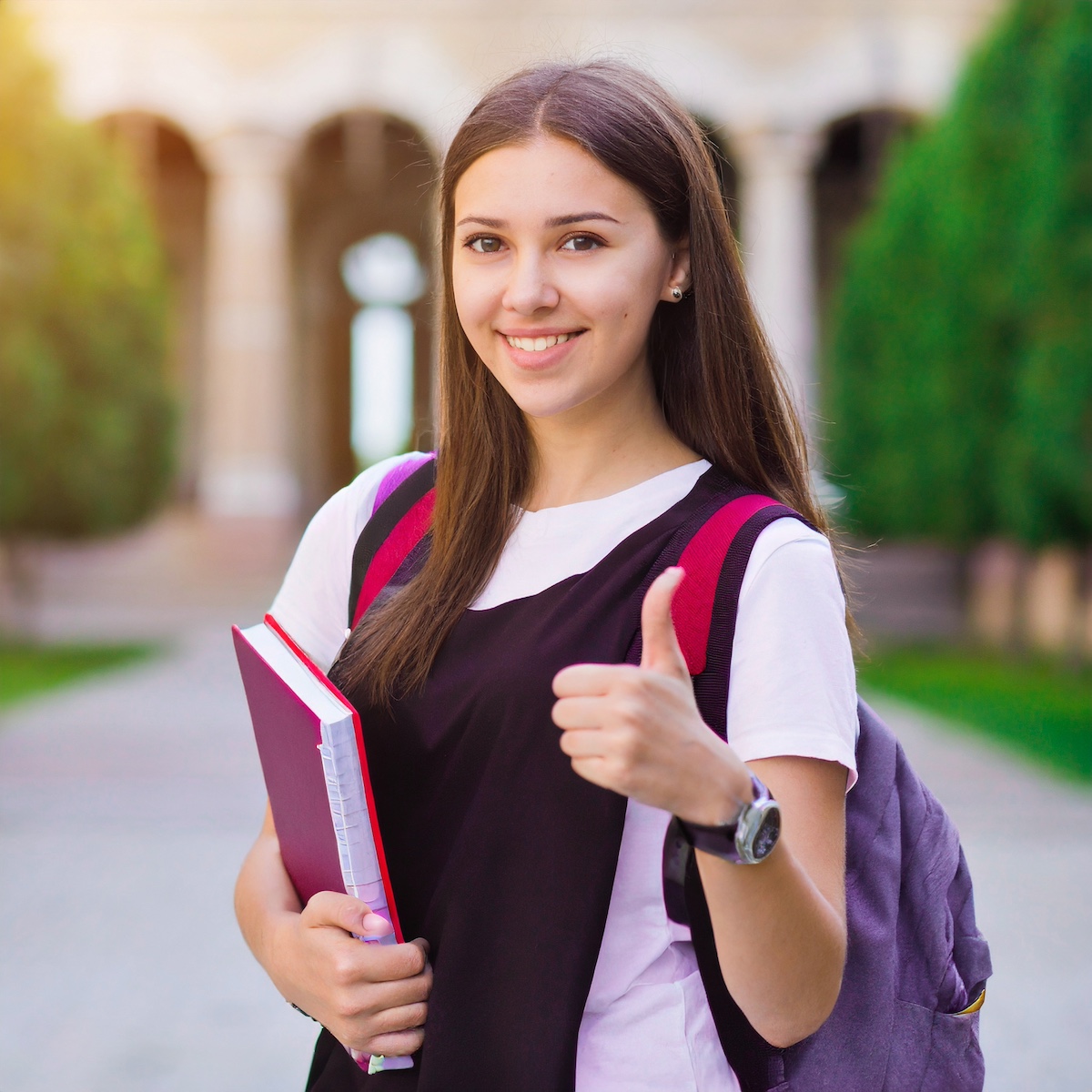 Confident student with books, ready for their English exam